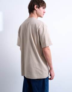Model wearing 5 pack relaxed fit t-shirt in black, white, beige, sage and charcoal 