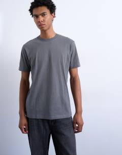 Model wearing 7 pack classic t-shirt in black, white, brown, navy, charcoal, ecru and brown 