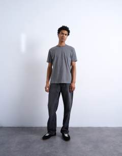 Model wearing 7 pack classic t-shirt in black, white, brown, navy, charcoal, ecru and brown 