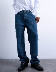 Model wearing Baggy carpenter jean in mid wash