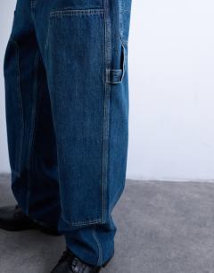 Model wearing Baggy carpenter jean in mid wash