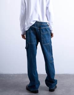 Model wearing Baggy carpenter jean in mid wash