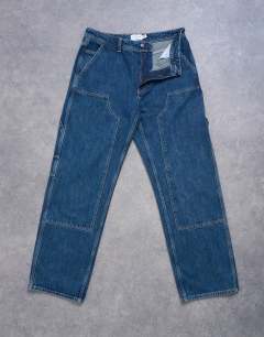 Model wearing Baggy carpenter jean in mid wash