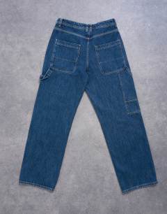 Model wearing Baggy carpenter jean in mid wash