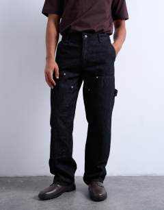 Model wearing Baggy carpenter jean in raw black