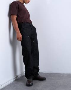 Model wearing Baggy carpenter jean in raw black