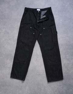 Model wearing Baggy carpenter jean in raw black