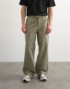Model wearing Baggy fit canvas cargo trouser in olive green