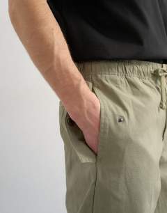 Model wearing Baggy fit canvas cargo trouser in olive green