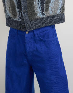 Model wearing Baggy fit cord trouser in cobalt blue