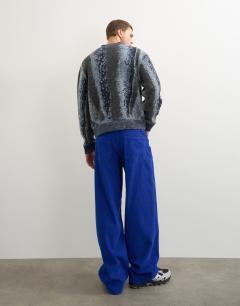 Model wearing Baggy fit cord trouser in cobalt blue