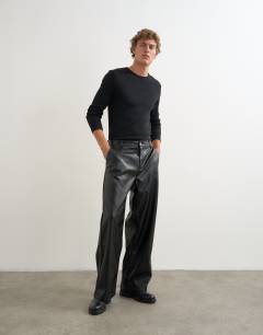 Model wearing Baggy fit faux leather trouser in black