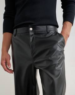 Model wearing Baggy fit faux leather trouser in black