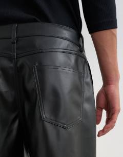 Model wearing Baggy fit faux leather trouser in black