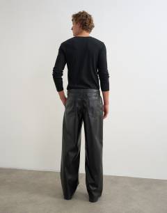 Model wearing Baggy fit faux leather trouser in black
