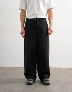 Model wearing Baggy fit herringbone trousers in black