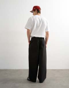Model wearing Baggy fit herringbone trousers in black