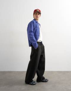 Model wearing Baggy fit herringbone trousers in black