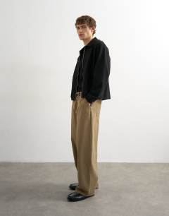 Model wearing Baggy fit herringbone trousers in khaki