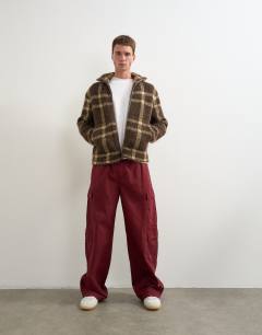 Model wearing Baggy fit nylon ripstop cargos in burnt red