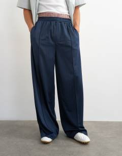 Model wearing Baggy fit stripe tricot jogger in navy