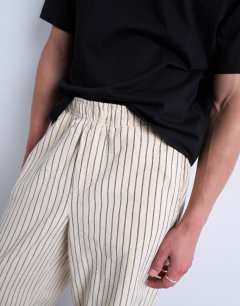 Model wearing Baggy fit stripe trouser in ecru