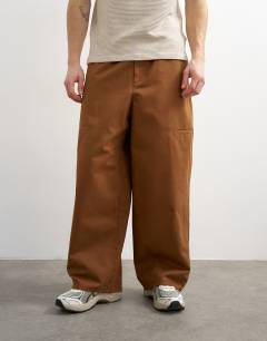 Model wearing Baggy fit trousers with side pockets in brown