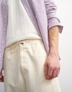 Model wearing Baggy fit trousers with side pockets in cream