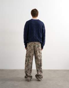 Model wearing Baggy fit twill cargo in camo print