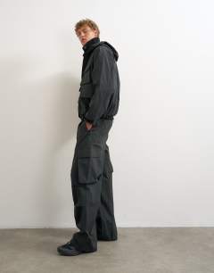 Model wearing Baggy fit waterproof nylon utility trouser in black