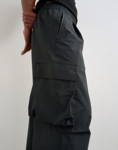 Model wearing Baggy fit waterproof nylon utility trouser in black