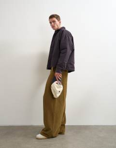 Model wearing Balloon fit cord trouser with pleats in camel