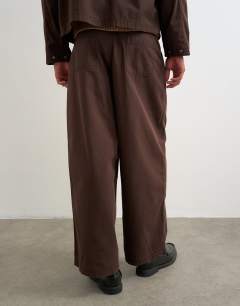 Model wearing Balloon fit herringbone twill trouser in brown