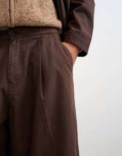Model wearing Balloon fit herringbone twill trouser in brown