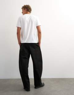 Model wearing Barrel fit trouser in black