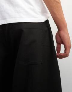 Model wearing Barrel fit trouser in black