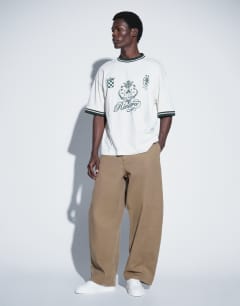Model wearing Barrel fit trouser in tan