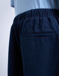 Model wearing Barrel trouser in front pockets and tie detail in navy
