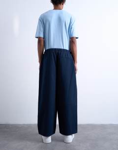 Model wearing Barrel trouser in front pockets and tie detail in navy