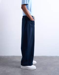 Model wearing Barrel trouser in front pockets and tie detail in navy