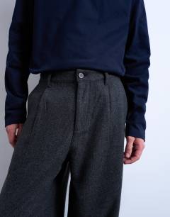 Model wearing Barrel trousers in herringbone warm handle in grey