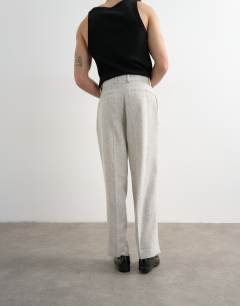 Model wearing Boucle textured wide leg trousers in cream