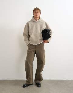 Model wearing Boxy fit brushed borg hoodie in stone