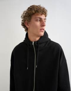 Model wearing Boxy fit funnel neck hoodie in black