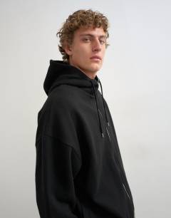 Model wearing Boxy fit funnel neck hoodie in black