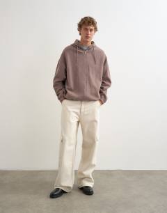 Model wearing Boxy fit funnel neck hoodie in putty