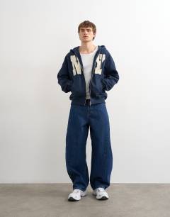 Model wearing Boxy fit hoodie with front NY chenille patch in navy