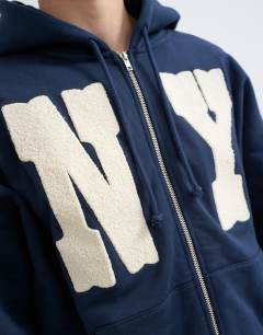 Model wearing Boxy fit hoodie with front NY chenille patch in navy