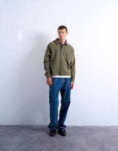 Model wearing Boxy fit  polo sweat in khaki in scuba-style fabric