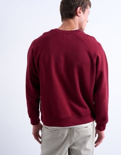 Model wearing Boxy fit raglan sweatshirt in burgundy